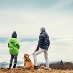 people hiking with a dog