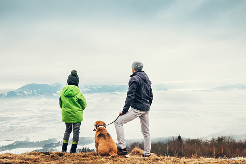 people hiking with a dog