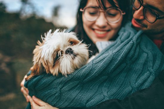 Couple hugging deaf dog