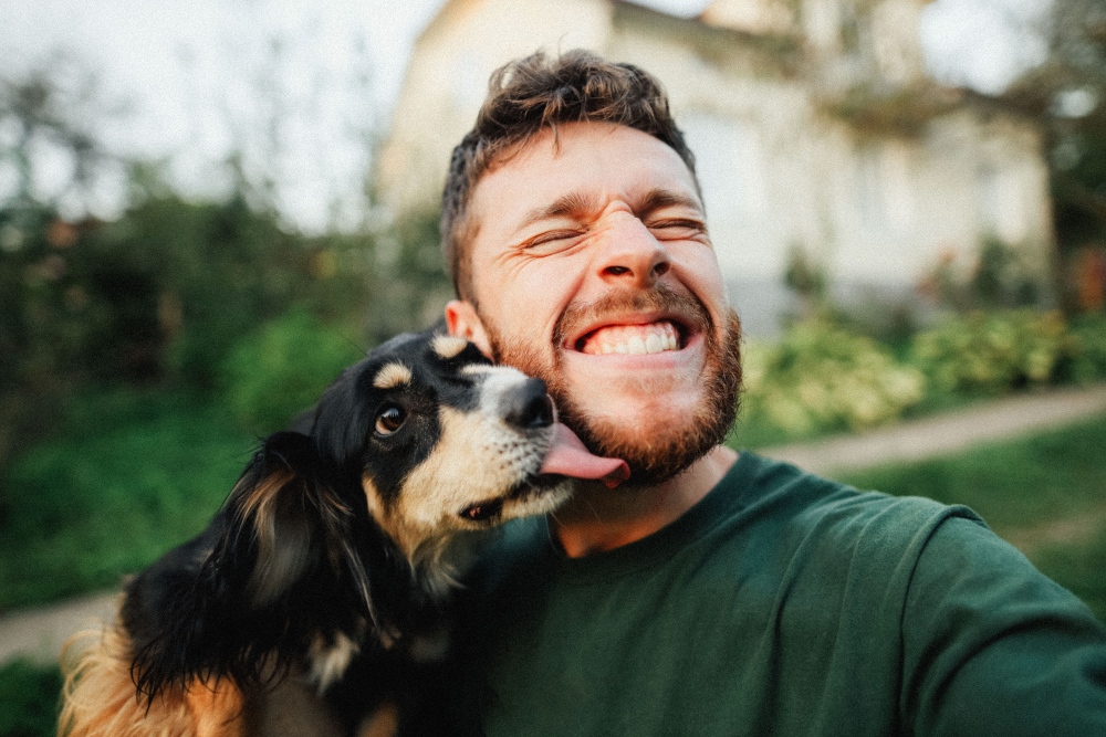 dog licking man's face