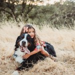 girl hugging bernese mountain dog