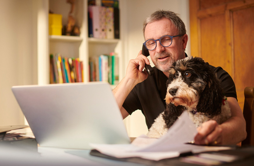 Man budgeting with dog