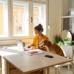 woman and dog on laptop