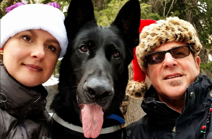 Baron, a black shepherd, with his pet parents.