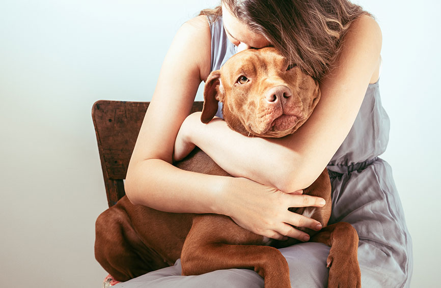 Woman hugging dog