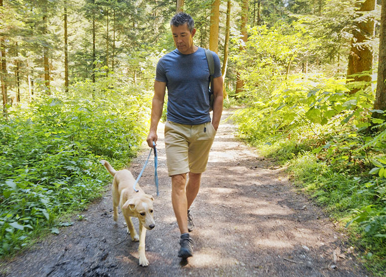 Man walking dog in nature